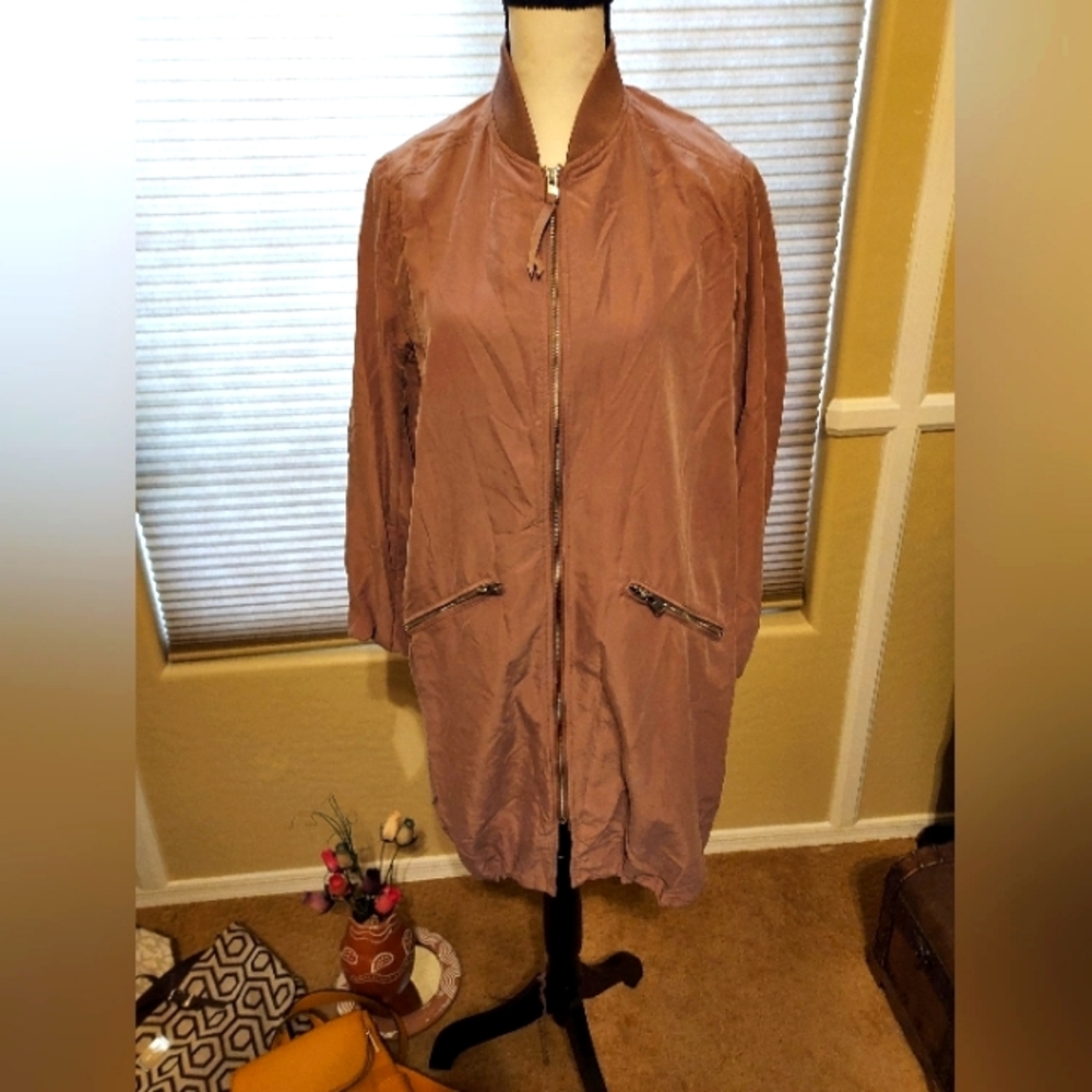 Lightweight jacket with zippers pockets in front drawstring around the bottom